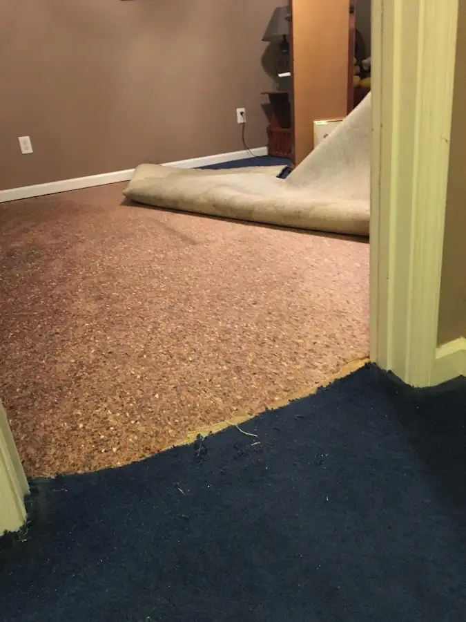 Carpet pad removal revealing water damage during Water Mitigation Services in Austell